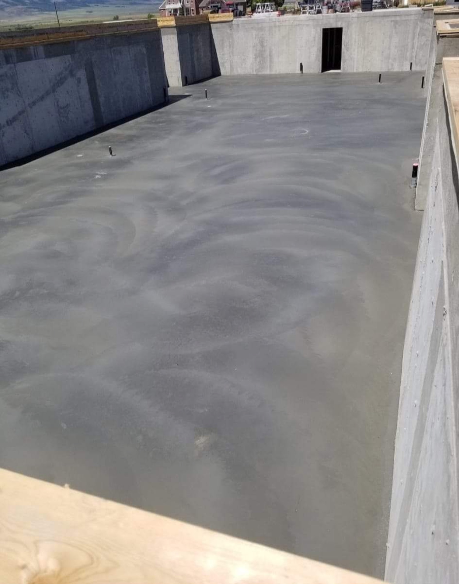 Concrete basement floor slab poured inside poured foundation walls on an Eastern Idaho home by Skinner Customs